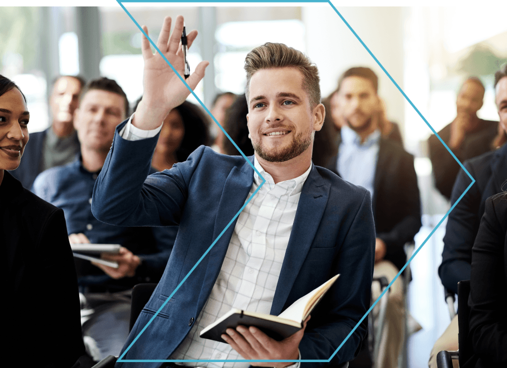 Man raising hand in real estate training class