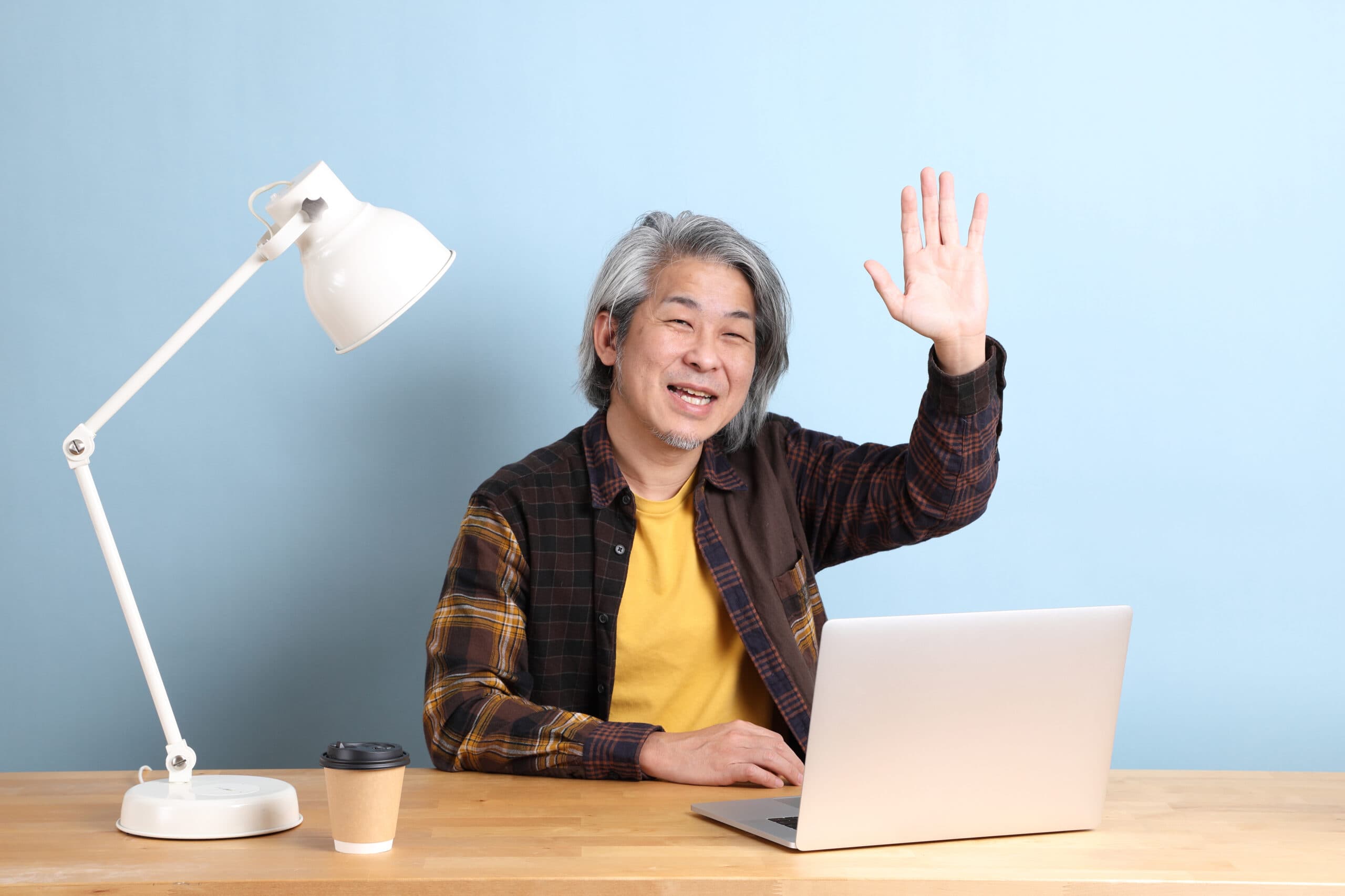 Friendly instructor waving at desk