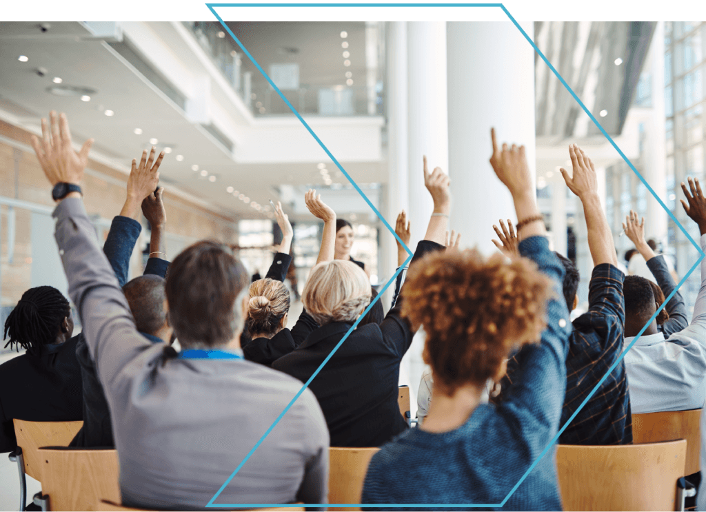 Students raising hands in a commercial real estate seminar